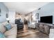 Bright living room featuring stylish furniture, a modern TV console, and an open layout to the kitchen at 5601 N Ocean Blvd. # E-113, Myrtle Beach, SC 29577