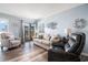Comfortable living room with wood floors, cozy seating, and a sliding glass door to a balcony at 5601 N Ocean Blvd. # E-113, Myrtle Beach, SC 29577