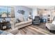 An open-concept living room with wood floors, cozy seating, and access to the kitchen at 5601 N Ocean Blvd. # E-113, Myrtle Beach, SC 29577