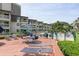 Exterior of a condo complex with a pool, deck with lounge chairs, and tables with umbrellas for relaxing by the pool at 5601 N Ocean Blvd. # E-113, Myrtle Beach, SC 29577