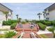 Exterior deck with lounge chairs and tables leading to an ocean view in a lush tropical landscaping setting at 5601 N Ocean Blvd. # E-113, Myrtle Beach, SC 29577