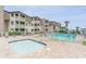 Community pool and hot tub near a condo complex featuring people swimming and enjoying the sun at 5601 N Ocean Blvd. # E-113, Myrtle Beach, SC 29577