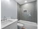 Stylish bathroom boasting a bathtub, shower, vanity with quartz countertop, and gray herringbone-patterned tile at 6001-Mh13A S Kings Hwy., Myrtle Beach, SC 29575