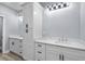 Bright bathroom featuring double sinks with white cabinetry, quartz countertops, and sleek matte black hardware at 6001-Mh13A S Kings Hwy., Myrtle Beach, SC 29575