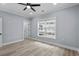Bedroom with gray walls, light wood floors, white trim, and a ceiling fan at 6001-Mh13A S Kings Hwy., Myrtle Beach, SC 29575