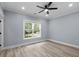 A bedroom with light blue walls, a window to the outside, light wood floors, and a ceiling fan at 6001-Mh13A S Kings Hwy., Myrtle Beach, SC 29575