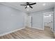 Bedroom with gray walls, light wood floors, white trim, and access to a bathroom at 6001-Mh13A S Kings Hwy., Myrtle Beach, SC 29575