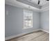 Bright bedroom featuring modern floors, a tray ceiling and a window with a view at 6001-Mh13A S Kings Hwy., Myrtle Beach, SC 29575