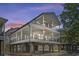 Stunning three-story coastal home featuring multi-level covered porches and ample outdoor living space at 6001-Mh13A S Kings Hwy., Myrtle Beach, SC 29575