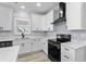 Kitchen with a black stainless dishwasher and stove, marble countertops, white cabinets, and a black faucet at 6001-Mh13A S Kings Hwy., Myrtle Beach, SC 29575