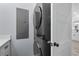 Laundry room with stacked washer and dryer adjacent to white door and cabinets at 6001-Mh13A S Kings Hwy., Myrtle Beach, SC 29575