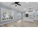 Open-concept living room with light wood floors, a ceiling fan, and an island-style kitchen with stainless appliances at 6001-Mh13A S Kings Hwy., Myrtle Beach, SC 29575