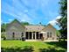 Well-maintained backyard with a large patio, screened-in porch, and ample space for outdoor entertainment at 6400 Longwood Dr., Murrells Inlet, SC 29576