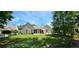 Spacious backyard featuring a screened porch, patio furniture, and lush green lawn, perfect for outdoor living at 6400 Longwood Dr., Murrells Inlet, SC 29576