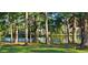 A serene and picturesque backyard pond surrounded by mature trees in a tranquil neighborhood at 6400 Longwood Dr., Murrells Inlet, SC 29576