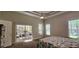 Bright primary bedroom with attached porch for outdoor enjoyment, two windows and a ceiling fan at 6400 Longwood Dr., Murrells Inlet, SC 29576