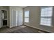 Cozy bedroom featuring a neutral carpet, a closet with bi-fold doors, and windows for natural light at 6400 Longwood Dr., Murrells Inlet, SC 29576