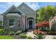 Inviting front entrance with a brick facade, manicured landscaping, and hanging flower baskets at 6400 Longwood Dr., Murrells Inlet, SC 29576