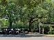 Row of golf carts parked near a lush green area, offering easy access for golf enthusiasts at 6400 Longwood Dr., Murrells Inlet, SC 29576