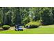 Scenic view of a golfer driving a golf cart on a sunny, green golf course at 6400 Longwood Dr., Murrells Inlet, SC 29576