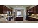 Spacious kitchen featuring dark wood cabinets, a center island, and stainless steel appliances at 6400 Longwood Dr., Murrells Inlet, SC 29576