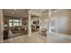 Open-concept living room and dining area with hardwood floors, large windows, and neutral paint at 6400 Longwood Dr., Murrells Inlet, SC 29576