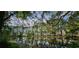 Scenic view of a tranquil pond reflecting surrounding trees and homes in a lush, peaceful community at 6400 Longwood Dr., Murrells Inlet, SC 29576