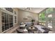 Beautiful sunroom with outdoor dining and lounge area, lots of natural light and a ceiling fan at 6400 Longwood Dr., Murrells Inlet, SC 29576