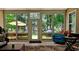 All-seasons sunroom features tile floors, outdoor seating, dining, a ceiling fan, and scenic views of the outdoors at 6400 Longwood Dr., Murrells Inlet, SC 29576