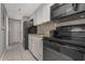 Compact kitchen with white cabinets and black appliances at 6900 N Ocean Blvd. # 842, Myrtle Beach, SC 29577