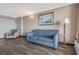 Cozy living room featuring a plush blue sofa and a comfortable armchair, illuminated by a stylish lamp at 6900 N Ocean Blvd. # 842, Myrtle Beach, SC 29577