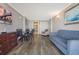 Open living room with dining table, blue couch, and wood floors at 6900 N Ocean Blvd. # 842, Myrtle Beach, SC 29577