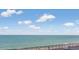 Calm ocean view with clear skies and clouds, seen from a tiled balcony with seating at 6900 N Ocean Blvd. # 842, Myrtle Beach, SC 29577