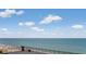 Wide ocean view from a high balcony with plants and seating, overlooking a sandy beach at 6900 N Ocean Blvd. # 842, Myrtle Beach, SC 29577