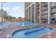 Inviting outdoor pool area with lounge chairs and colorful water play area at resort at 6900 N Ocean Blvd. # 842, Myrtle Beach, SC 29577