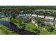 Expansive aerial view of the neighborhood nestled among trees, showcasing the community's lake and golf course at 695 Riverwalk Dr. # 101, Myrtle Beach, SC 29579