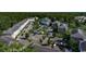 Aerial view of condo buildings with ample parking surrounded by lush green trees at 695 Riverwalk Dr. # 101, Myrtle Beach, SC 29579