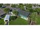 An aerial view of the building with a pool, parking and a small shed surrounded by vibrant green lawns and trees at 695 Riverwalk Dr. # 101, Myrtle Beach, SC 29579