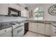Functional kitchen area with white cabinetry, sleek appliances, and granite countertops at 695 Riverwalk Dr. # 101, Myrtle Beach, SC 29579
