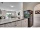 Bright kitchen features granite counters, white cabinets and stainless steel refrigerator at 695 Riverwalk Dr. # 101, Myrtle Beach, SC 29579