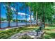 Scenic view of the waterway and walking path with bench surrounded by mature trees at 695 Riverwalk Dr. # 101, Myrtle Beach, SC 29579