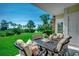 Covered outdoor patio with seating and views of the golf course at 695 Riverwalk Dr. # 101, Myrtle Beach, SC 29579