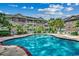 Beautiful community pool with ample seating, surrounded by well-maintained landscaping and elegant condo buildings at 695 Riverwalk Dr. # 101, Myrtle Beach, SC 29579
