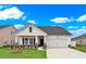 Charming one-story home features a manicured lawn, two-car garage, and covered entry way at 703 Laconic Dr., Myrtle Beach, SC 29588