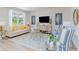Bright and airy living room with comfortable seating, large windows, and modern decor elements at 7366 Meadow Walk Loop, Loris, SC 29569