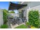 The back patio with retractable awning has an outdoor table set, water feature, and a sliding door to the home at 752 Hobonny Loop, Longs, SC 29568