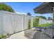 Lounge seating in the back yard features an umbrella for shade and a well-maintained privacy fence and landscaping at 752 Hobonny Loop, Longs, SC 29568