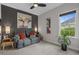 Charming bedroom area with a gray love seat and striking bull painting above an end table at 752 Hobonny Loop, Longs, SC 29568