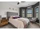 Elegant bedroom features a stylish gray upholstered bed with accent pillows, sitting beneath starburst wall decor at 752 Hobonny Loop, Longs, SC 29568