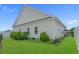 This home features an exterior with white siding and a lush green lawn, complemented by mature landscaping at 752 Hobonny Loop, Longs, SC 29568